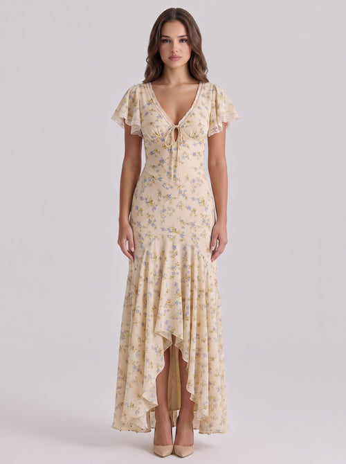 Brisconti Portofino Maxikleid in Beige mit Blumenprint, V-Ausschnitt, Spitzenbesatz und asymmetrischem Saum.